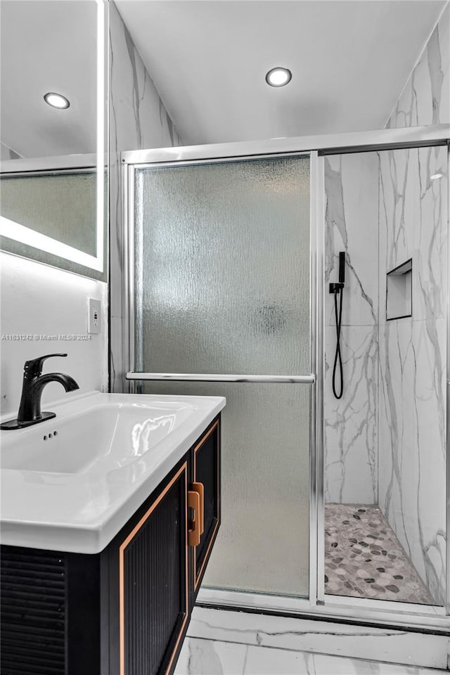 bathroom with a marble finish shower, recessed lighting, marble finish floor, and vanity