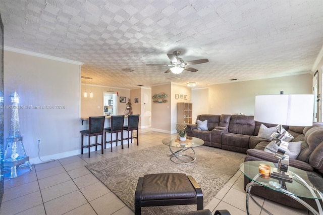 living area with baseboards, light tile patterned flooring, a ceiling fan, and crown molding