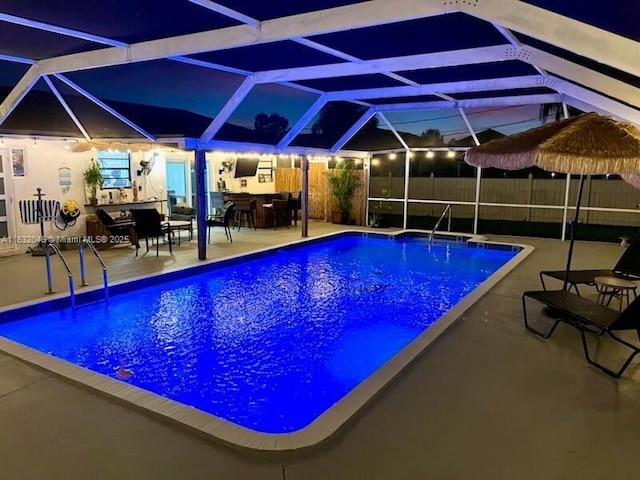 view of swimming pool featuring a fenced in pool, a lanai, fence, and a patio