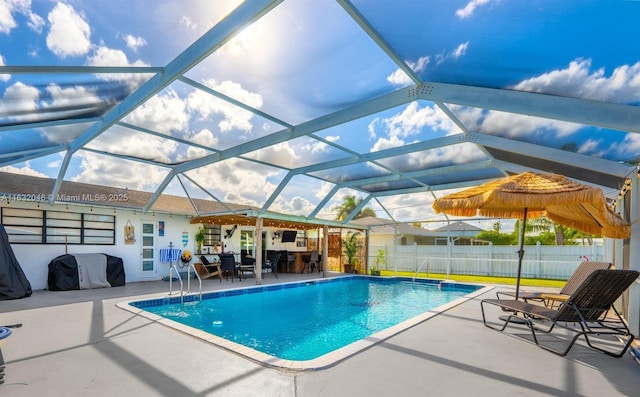 view of swimming pool featuring a fenced in pool, a patio area, a grill, fence, and a lanai