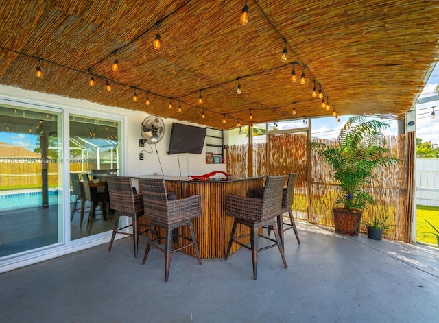 view of patio / terrace with fence and outdoor dry bar