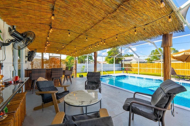 view of swimming pool with a lanai, a patio area, a fenced backyard, and a fenced in pool