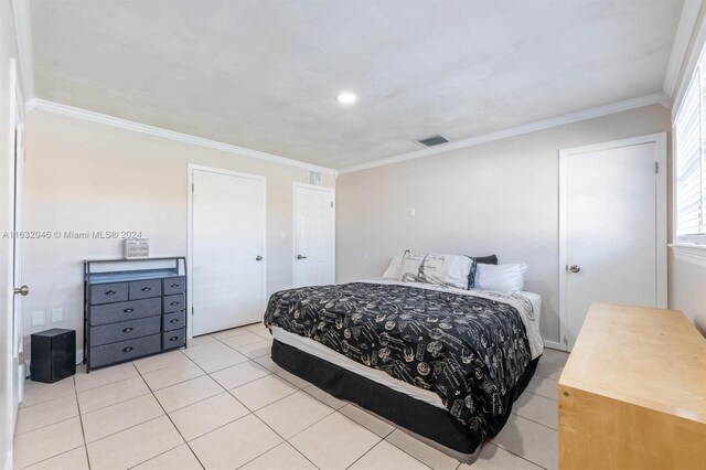 tiled bedroom featuring ornamental molding