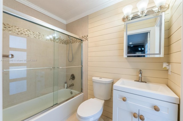 full bathroom with combined bath / shower with glass door, toilet, vanity, and ornamental molding