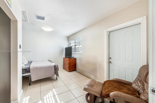 tiled bedroom featuring a closet