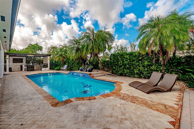 view of pool featuring pool water feature and a patio