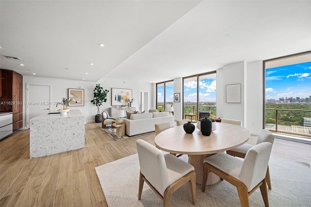 2678 Tigertail Ave Unit 1706, Miami, FL 33133 - dining area featuring a wall of windows, plenty of natural light, light wood-style floors, a city view, and recessed lighting