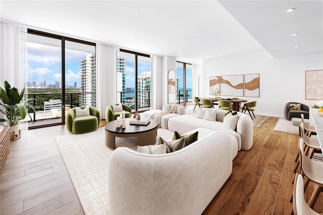 living room featuring floor to ceiling windows and wood-type flooring