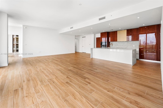 unfurnished living room featuring light hardwood / wood-style floors