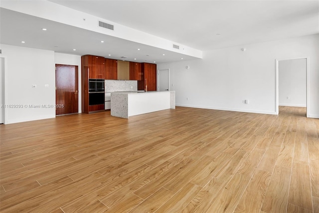 unfurnished living room with light hardwood / wood-style floors