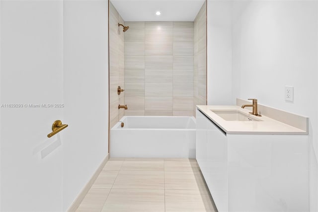 bathroom featuring tile patterned floors, vanity, and tiled shower / bath