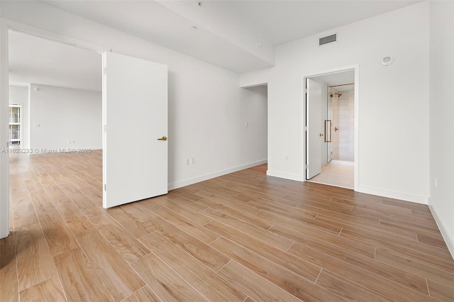 spare room with light hardwood / wood-style flooring