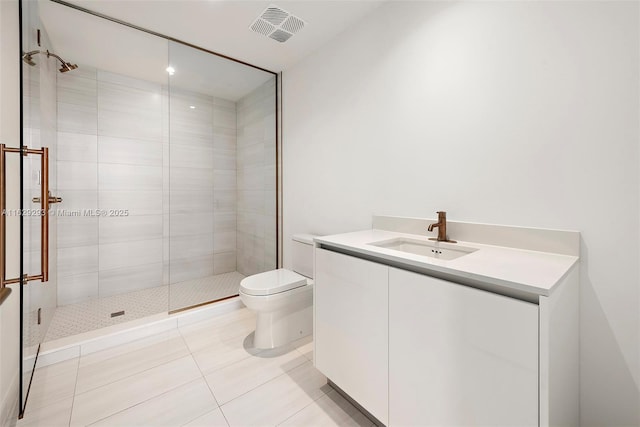 bathroom featuring tile patterned floors, vanity, toilet, and walk in shower