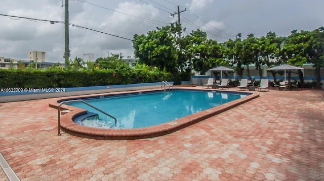 view of swimming pool featuring a patio area