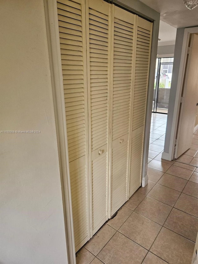 corridor featuring light tile patterned floors