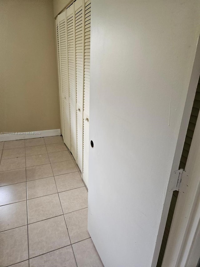 corridor with light tile patterned flooring