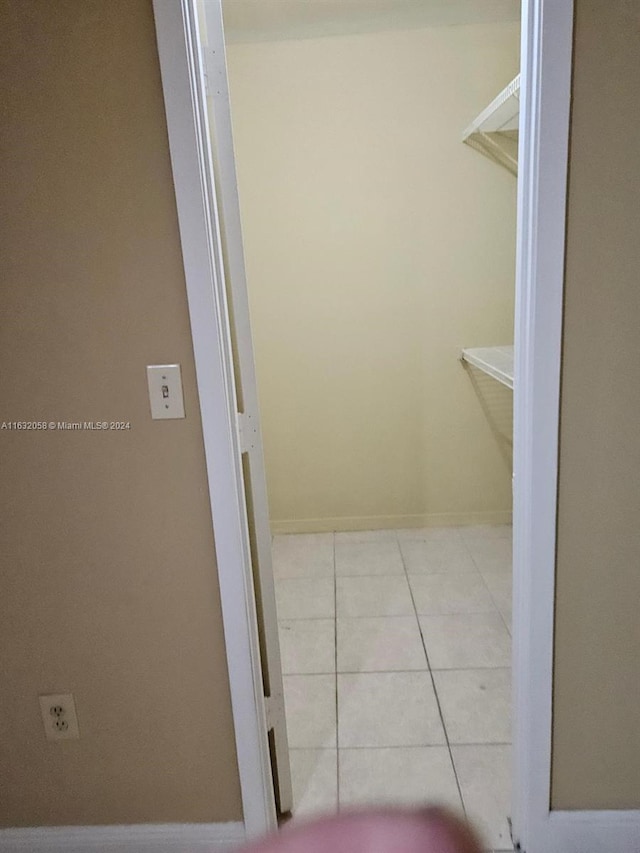 spacious closet with light tile patterned floors