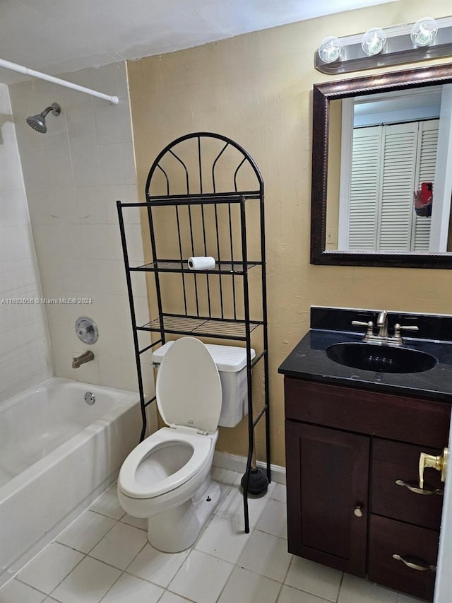 full bathroom featuring tile patterned flooring, vanity, toilet, and tiled shower / bath