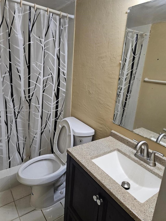 bathroom with tile patterned flooring, vanity, toilet, and curtained shower