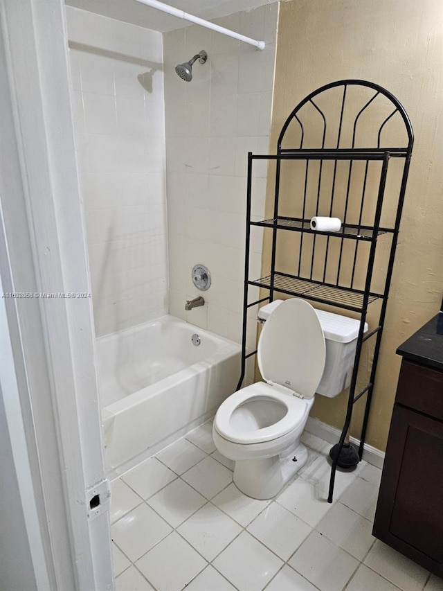 full bathroom with tile patterned flooring, vanity, tiled shower / bath combo, and toilet