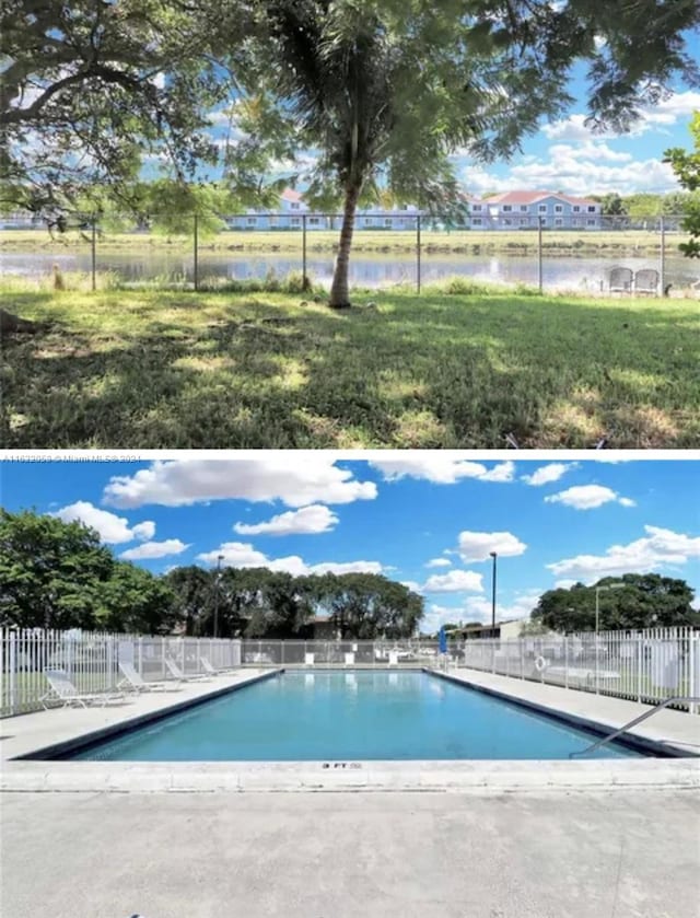 view of swimming pool featuring a water view