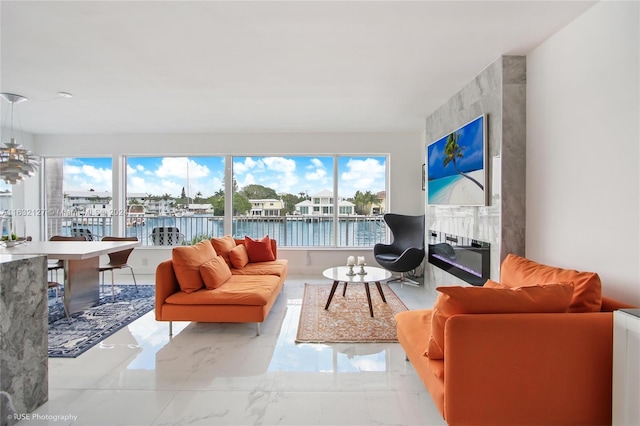 sunroom with a water view and a fireplace