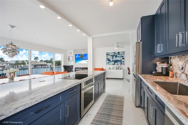 kitchen featuring blue cabinets, a water view, sink, and stainless steel appliances