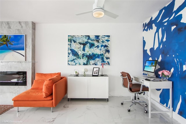 home office featuring ceiling fan and a fireplace