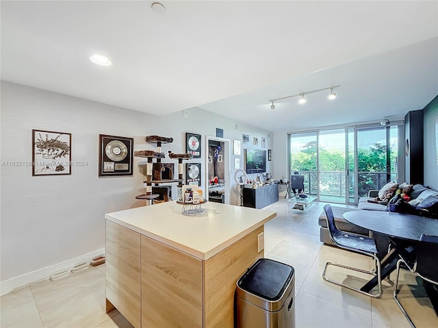 kitchen featuring a center island, light tile patterned floors, and track lighting