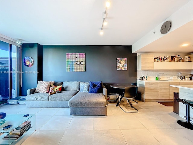 tiled living room featuring track lighting