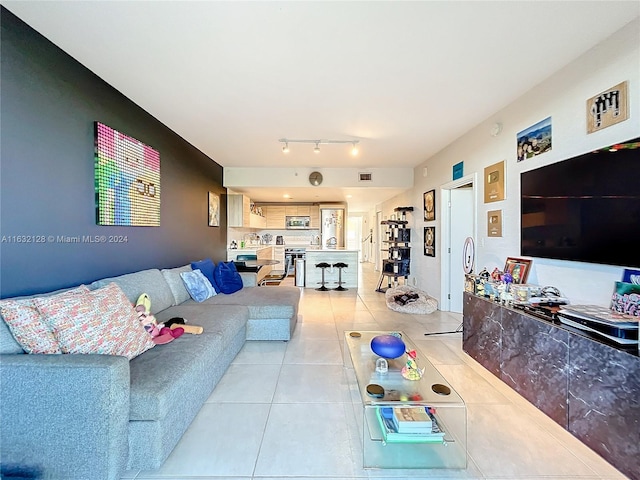 tiled living room with rail lighting