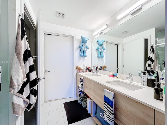 bathroom featuring tile patterned flooring and double sink vanity