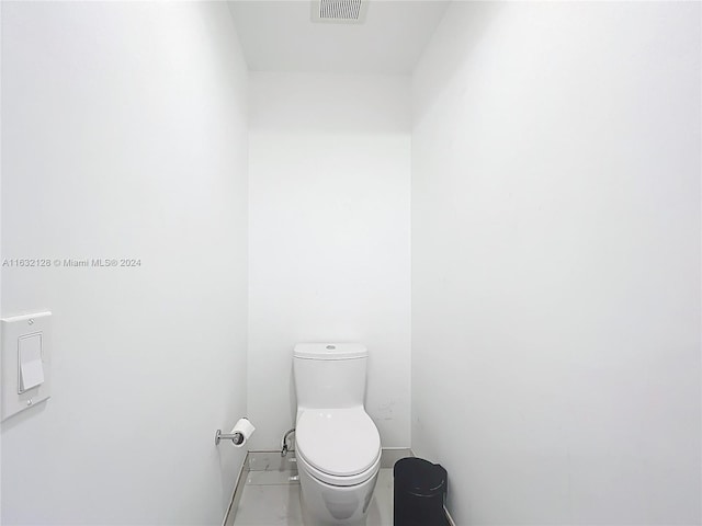 bathroom with tile patterned flooring and toilet