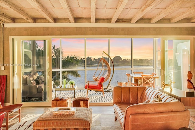 sunroom / solarium with a water view and wood ceiling