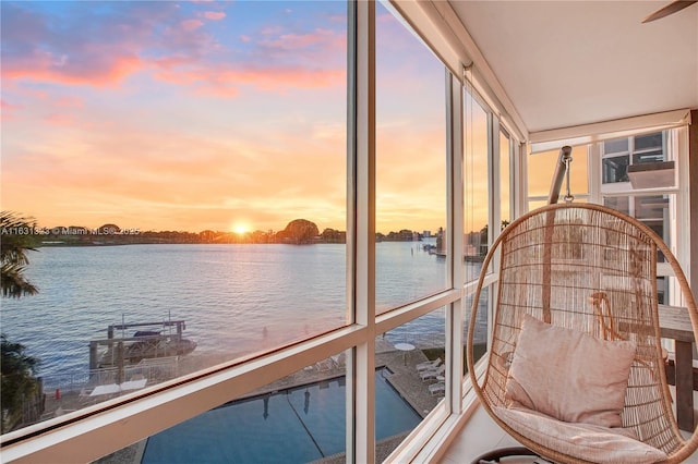 sunroom / solarium featuring a water view