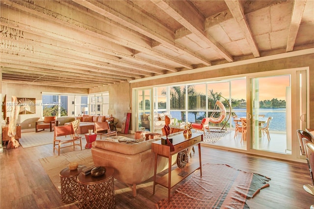 sunroom / solarium featuring a water view and a healthy amount of sunlight