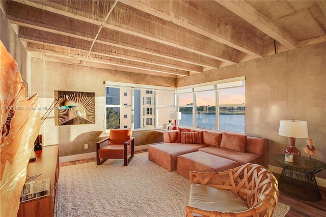 interior space featuring wood-type flooring, a water view, and beam ceiling