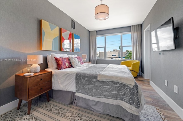 bedroom with hardwood / wood-style floors