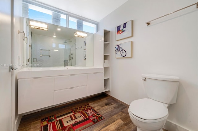 bathroom with toilet, vanity, an enclosed shower, and hardwood / wood-style flooring