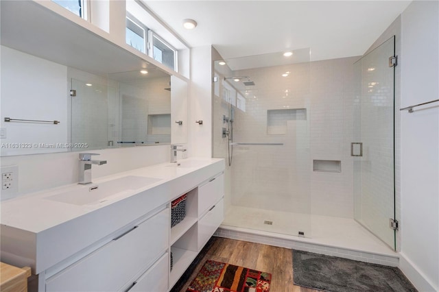 bathroom with vanity, wood-type flooring, walk in shower, and a wealth of natural light