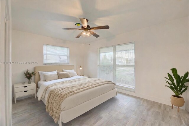 bedroom featuring ceiling fan and light hardwood / wood-style flooring