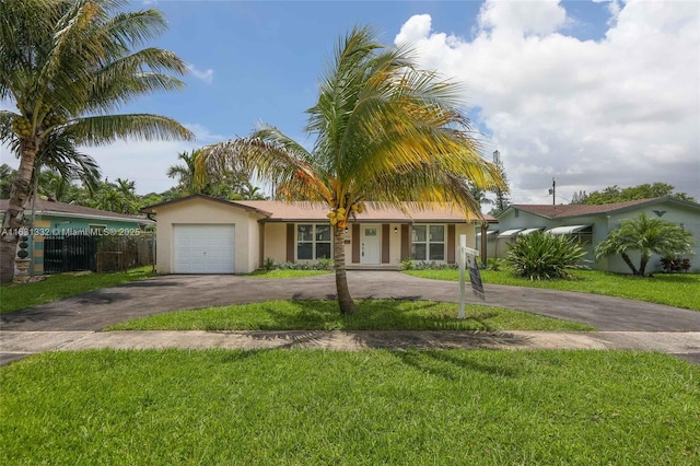 view of front of house with a front lawn and a garage