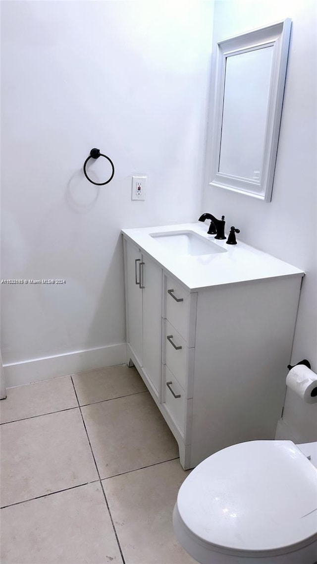 bathroom with tile patterned floors, toilet, and vanity