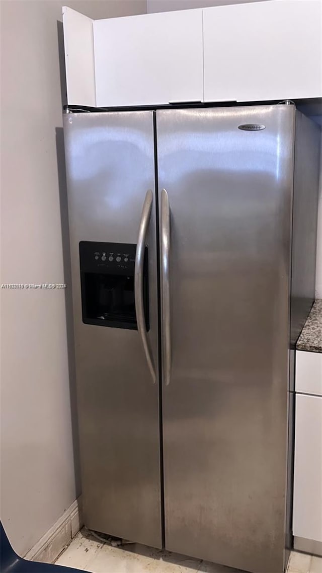 kitchen with white cabinetry and stainless steel fridge with ice dispenser