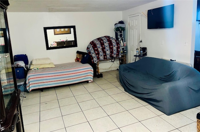 bedroom featuring light tile patterned flooring and vaulted ceiling