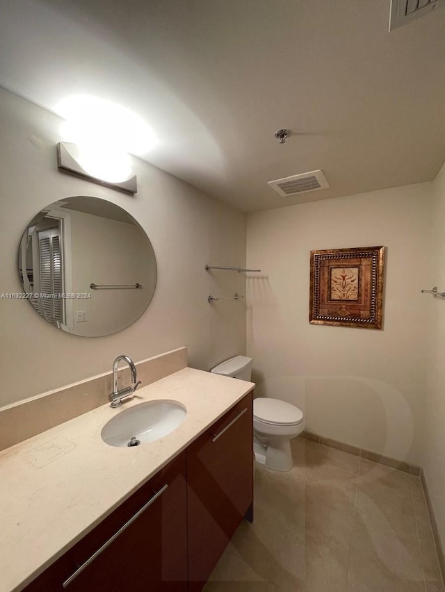 bathroom with tile patterned floors, toilet, and vanity