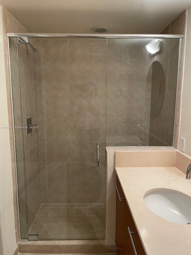 bathroom with vanity and a shower with shower door