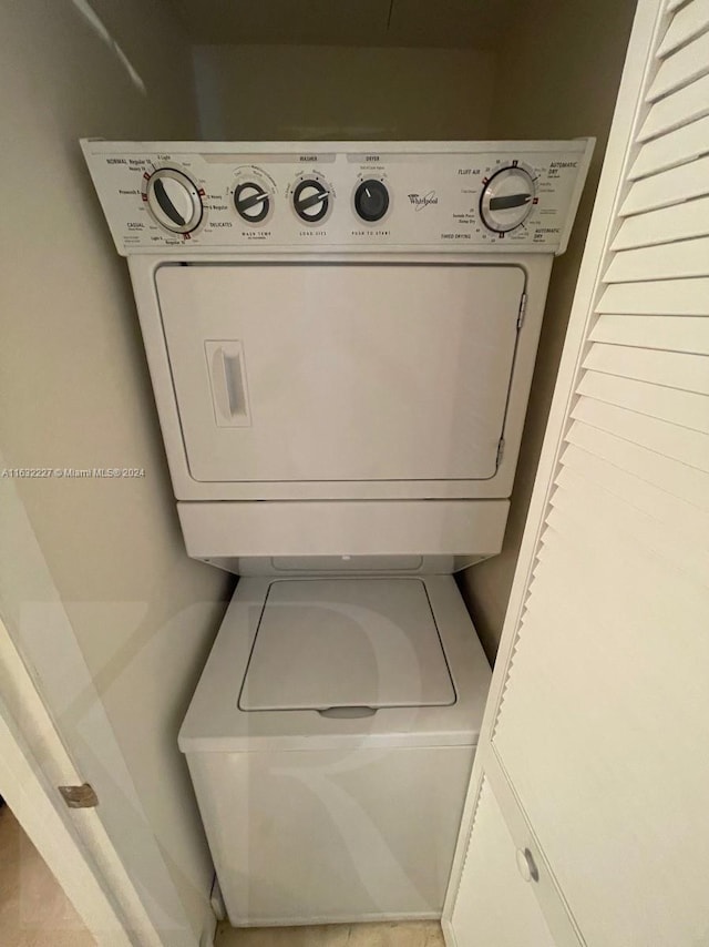 laundry area with stacked washer / dryer