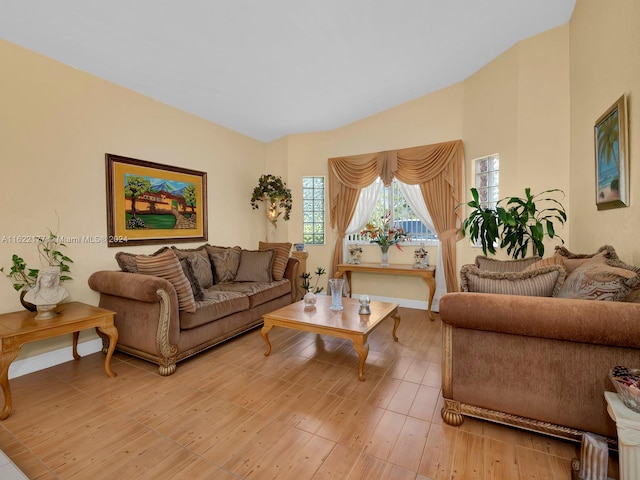 living room featuring vaulted ceiling and light wood-type flooring