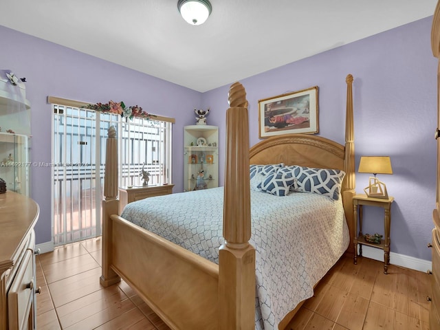 bedroom featuring access to outside and light wood-type flooring